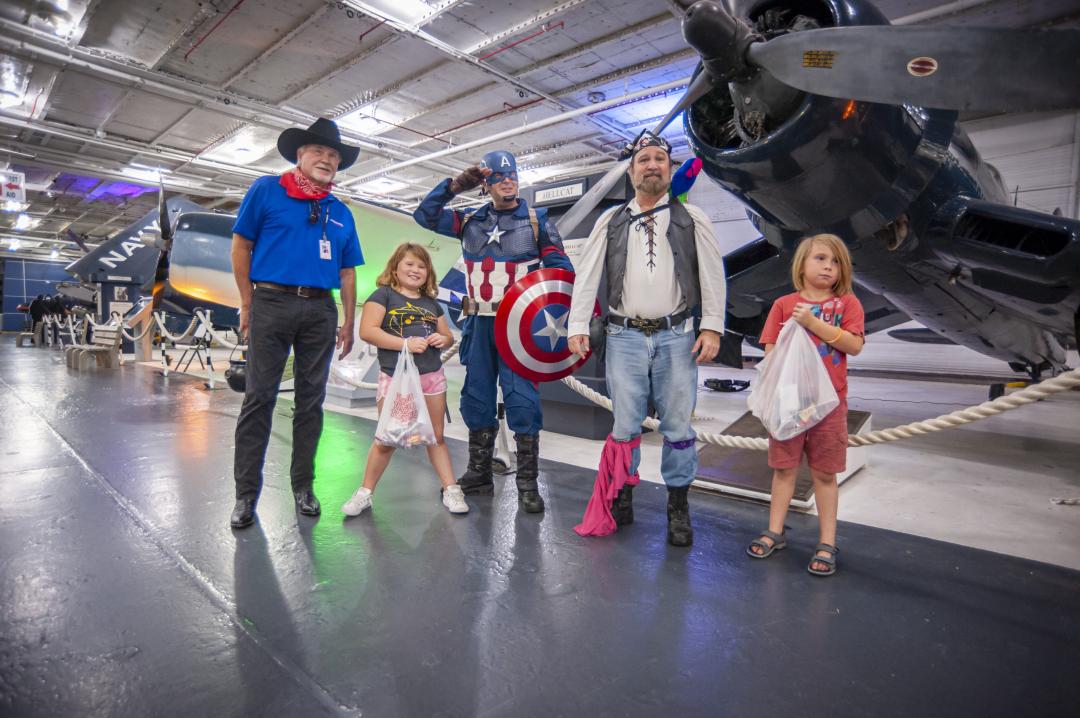 Group dressed up for Halloween. Cowboy, Captain America, Pirate to name a few.