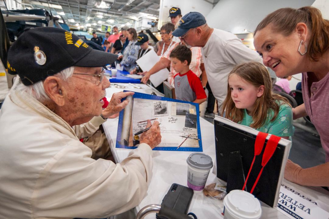 A Veteran speaking with some visitors