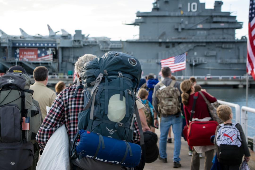 People carrying on backpacks and overnight bags for Operation Overnight